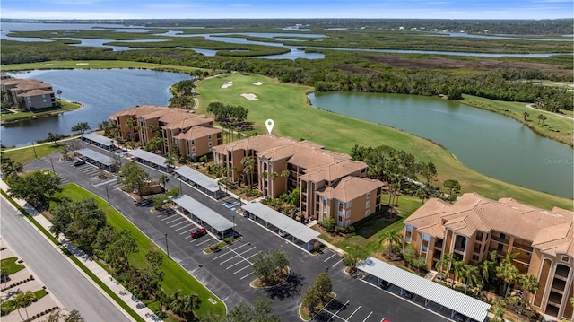 drone / aerial view of a golf course and a large body of water