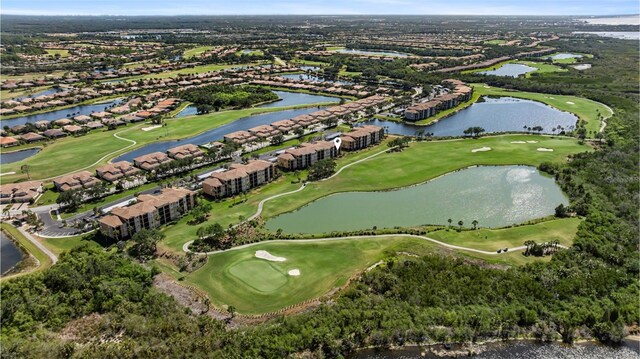 aerial overview of property's location with a golf course, a nearby body of water, and nearby suburban area