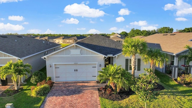 ranch-style home featuring a garage, a shingled roof, a residential view, decorative driveway, and stucco siding