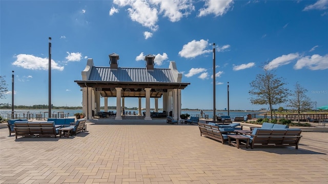 exterior space featuring an outdoor living space, a gazebo, and a water view
