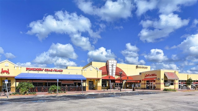 view of building exterior featuring uncovered parking