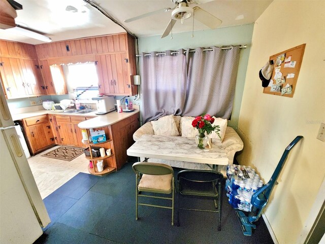 4221 26th St W, Bradenton, FL 34205 - kitchen featuring brown cabinets, ceiling fan, light countertops, freestanding refrigerator, and light floors