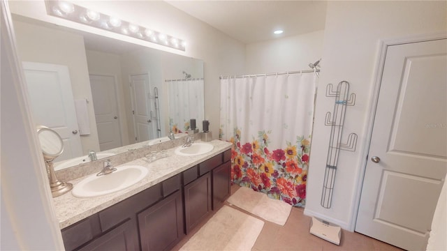 full bathroom featuring a sink, tile patterned floors, double vanity, and a shower with shower curtain