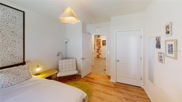 bedroom featuring visible vents and light wood-style floors