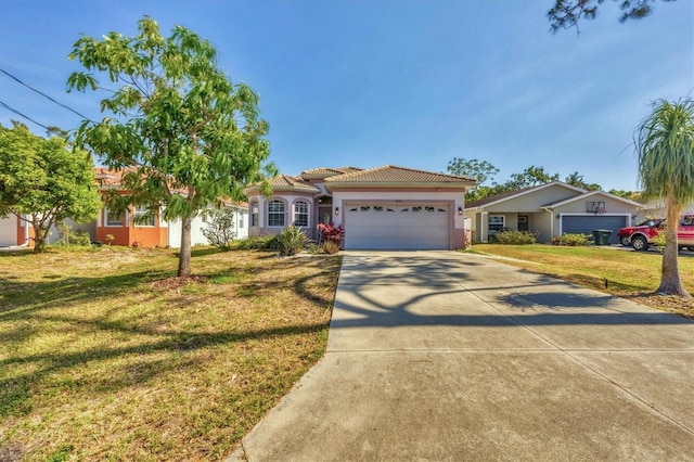 ranch-style house featuring a front yard, stucco siding, an attached garage, driveway, and a tile roof