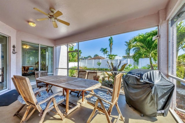 sunroom with plenty of natural light and a ceiling fan
