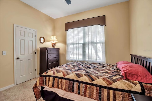 carpeted bedroom featuring a ceiling fan and baseboards