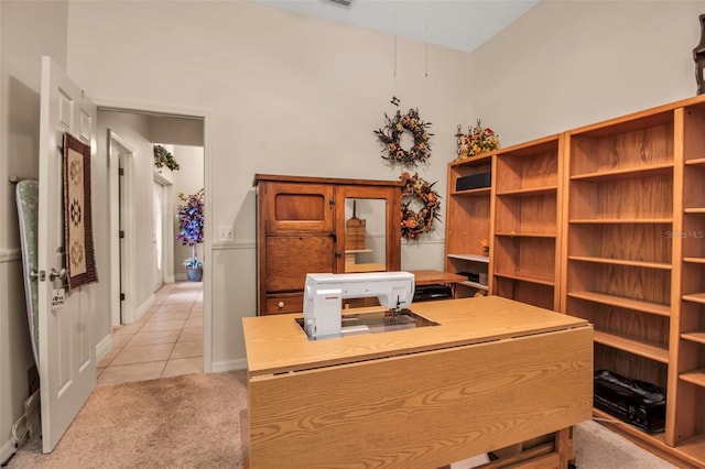 home office with light tile patterned floors, light carpet, and baseboards