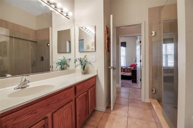 ensuite bathroom featuring tile patterned floors, ensuite bath, a tile shower, and vanity