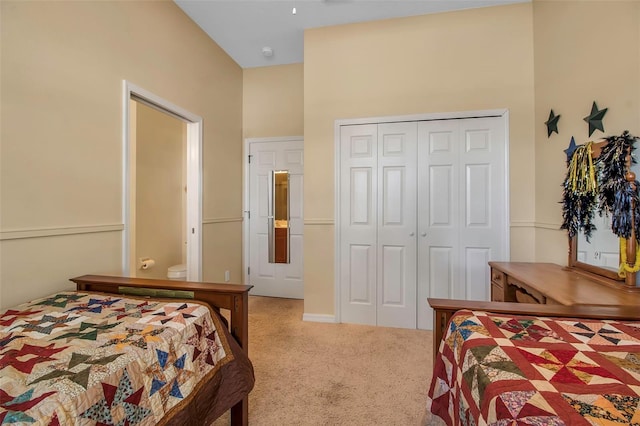 bedroom with a closet and light carpet
