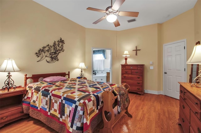 bedroom featuring baseboards, visible vents, a ceiling fan, and light wood-style flooring