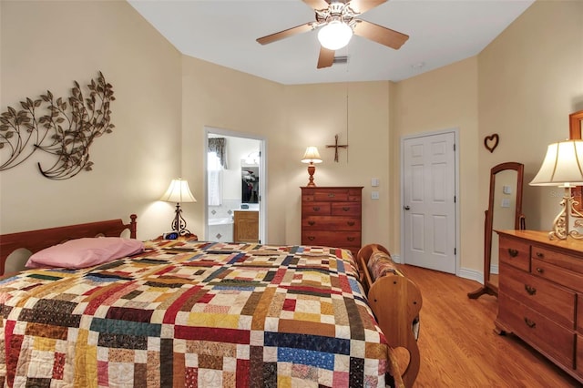 bedroom featuring a ceiling fan, connected bathroom, and light wood-style floors