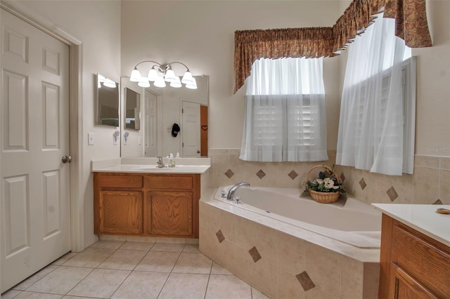 bathroom with a bath, tile patterned flooring, and vanity