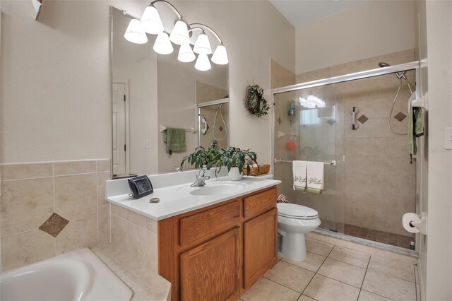 full bathroom with tile patterned floors, toilet, vanity, a stall shower, and a notable chandelier