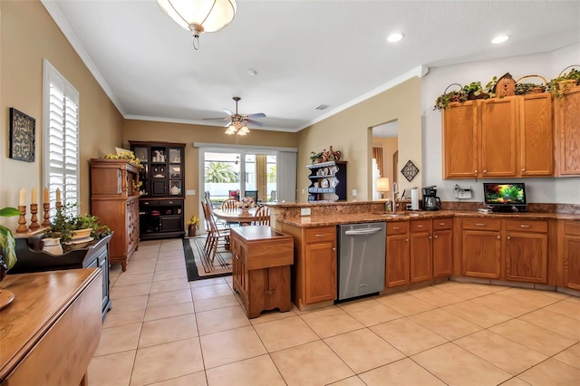 kitchen with brown cabinets, light tile patterned floors, a ceiling fan, a peninsula, and stainless steel dishwasher