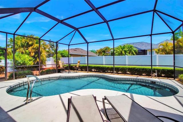 view of swimming pool with a patio, a lanai, a fenced backyard, and a fenced in pool