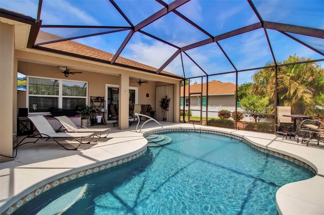 outdoor pool featuring a lanai, ceiling fan, and a patio area