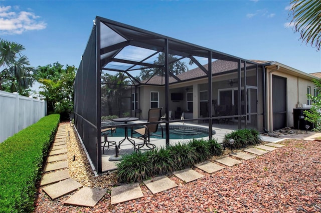 pool featuring a lanai, fence, and a patio area