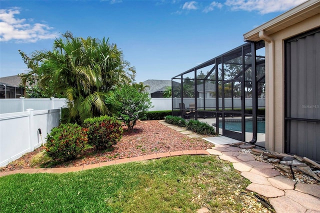 view of yard with a fenced in pool, a patio, glass enclosure, and a fenced backyard