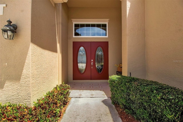 property entrance featuring stucco siding