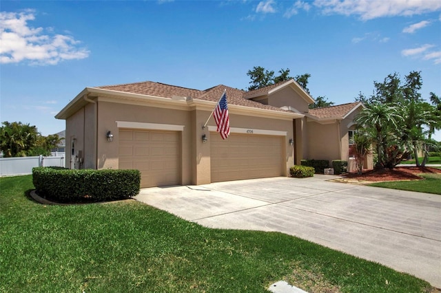 view of front of house with a garage, stucco siding, a front yard, and concrete driveway