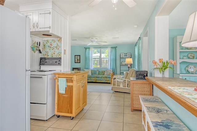 kitchen featuring a ceiling fan, light tile patterned floors, light countertops, open floor plan, and white appliances