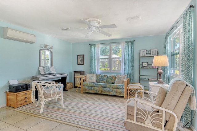 living area with visible vents, a wall mounted AC, and a healthy amount of sunlight