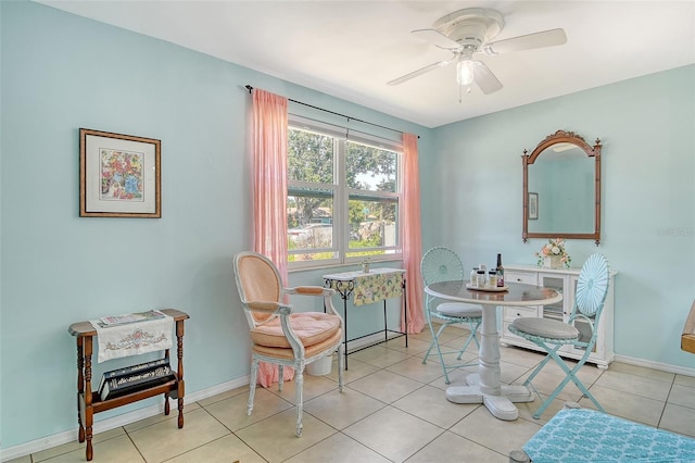 sitting room featuring light tile patterned floors, ceiling fan, and baseboards