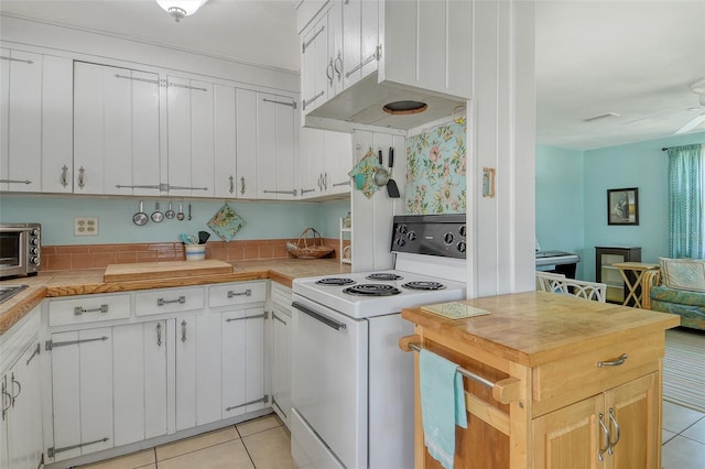 kitchen featuring visible vents, light tile patterned flooring, wooden counters, white cabinets, and electric stove