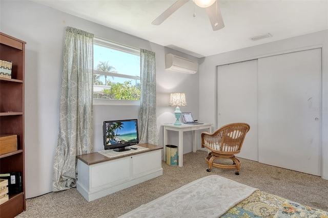 sitting room featuring a ceiling fan, an AC wall unit, carpet flooring, and visible vents
