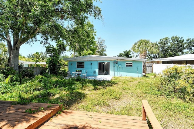 back of property with a fenced backyard and a wooden deck