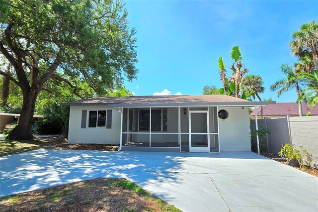 1722 Linhart Ave, Fort Myers, FL 33901 - rear view of property featuring stucco siding, a shingled roof, and a sunroom
