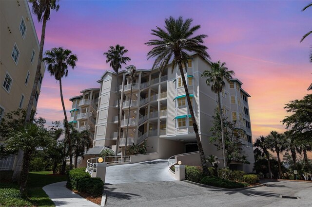 242 Hidden Bay Dr Unit 603, Osprey, FL 34229 - property at dusk with driveway and a view of apartment building / complex