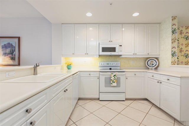 242 Hidden Bay Dr Unit 603, Osprey, FL 34229 - kitchen featuring white appliances, white cabinets, light countertops, and recessed lighting