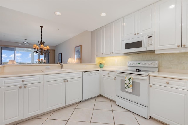 242 Hidden Bay Dr Unit 603, Osprey, FL 34229 - kitchen featuring white appliances, a chandelier, backsplash, white cabinetry, and recessed lighting