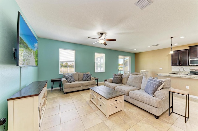 7822 110th Ave E, Parrish, FL 34219 - living area with baseboards, visible vents, light tile patterned floors, and ceiling fan
