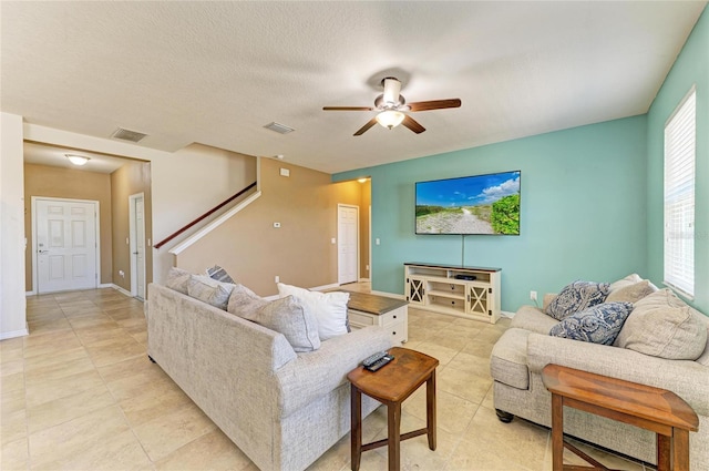 7822 110th Ave E, Parrish, FL 34219 - living area with stairway, light tile patterned flooring, ceiling fan, visible vents, and baseboards