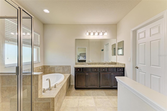 7822 110th Ave E, Parrish, FL 34219 - bathroom featuring a bath, a textured ceiling, a shower stall, and vanity