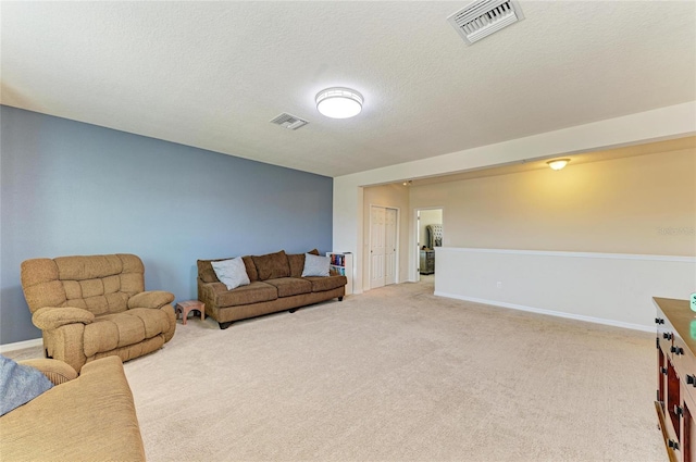 7822 110th Ave E, Parrish, FL 34219 - carpeted living room with a textured ceiling, visible vents, and baseboards