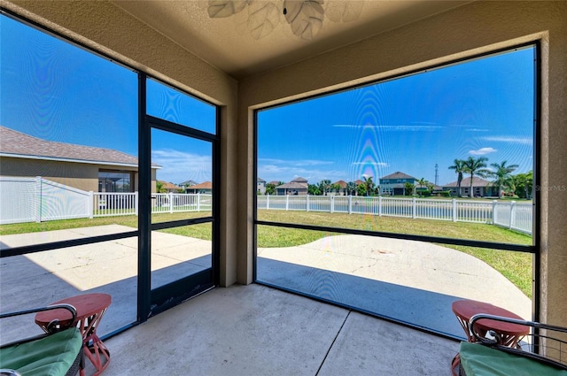 7822 110th Ave E, Parrish, FL 34219 - unfurnished sunroom with ceiling fan, a water view, and a residential view