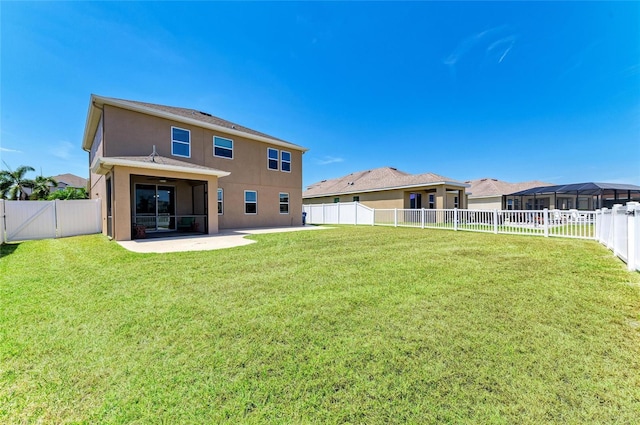 7822 110th Ave E, Parrish, FL 34219 - back of house featuring ceiling fan, a fenced backyard, stucco siding, and a patio area
