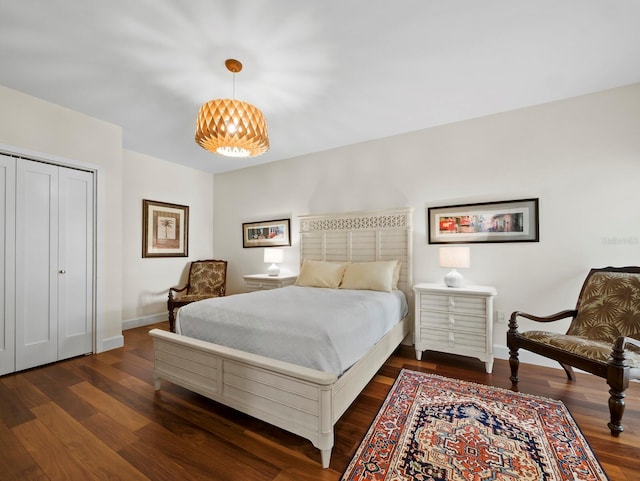 2282 Harbour Court Dr, Longboat Key, FL 34228 - bedroom with a notable chandelier, baseboards, dark wood finished floors, and a closet