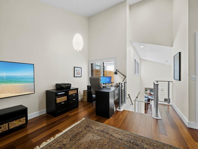 2282 Harbour Court Dr, Longboat Key, FL 34228 - office area with baseboards, a high ceiling, and dark wood-type flooring