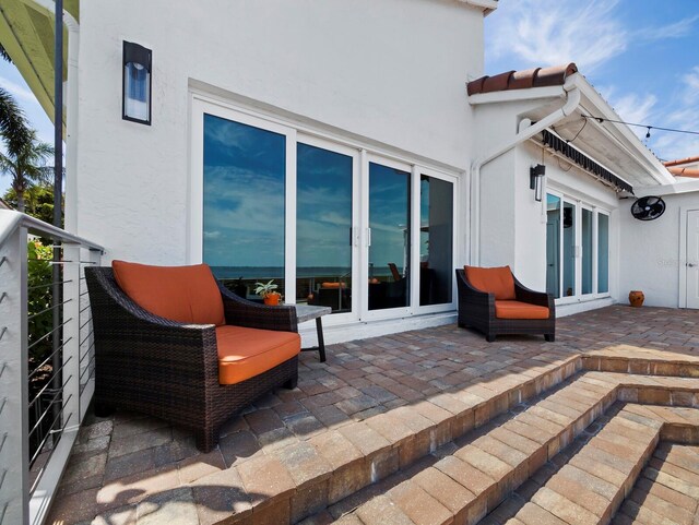 2282 Harbour Court Dr, Longboat Key, FL 34228 - rear view of property with a tiled roof, a patio area, and stucco siding