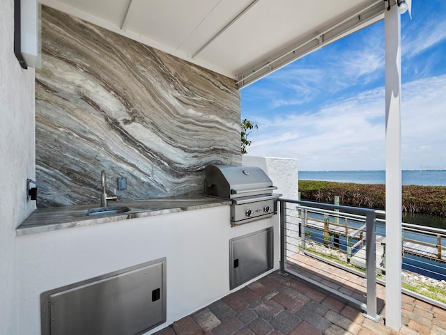 2282 Harbour Court Dr, Longboat Key, FL 34228 - exterior space featuring a sink, grilling area, an outdoor kitchen, a view of the beach, and a water view