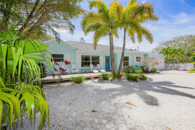 view of front of home featuring a deck and fence