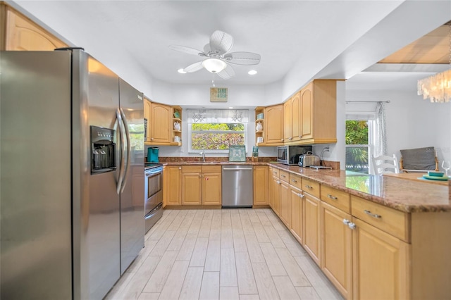 kitchen with open shelves, appliances with stainless steel finishes, plenty of natural light, and ceiling fan