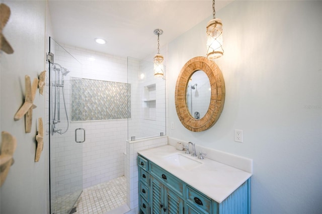bathroom featuring vanity, a stall shower, and recessed lighting