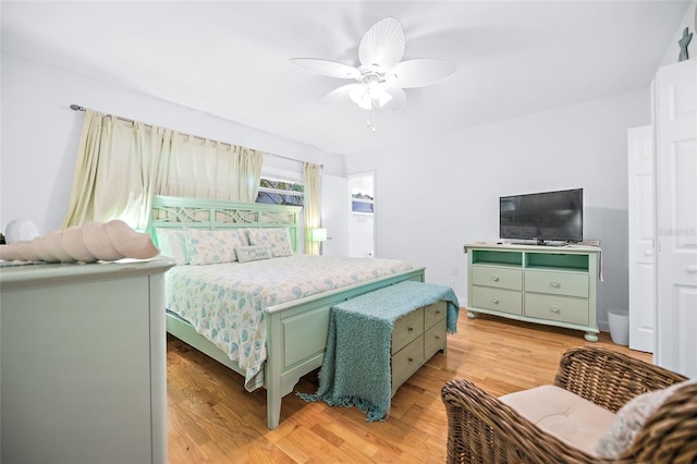 bedroom with a ceiling fan and light wood-style floors
