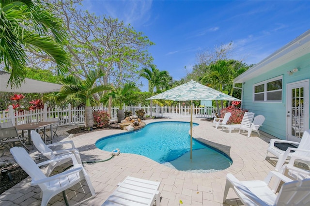 view of swimming pool featuring a patio, a fenced backyard, french doors, and a fenced in pool
